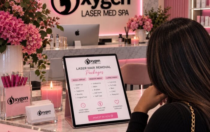Client reviewing laser hair removal package options on a tablet display at Oxygen Med Spa in Orland Park